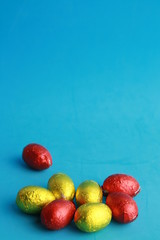 chocolate easter eggs, wrapped in yellow and red paper