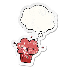 cartoon cupcake and thought bubble as a distressed worn sticker