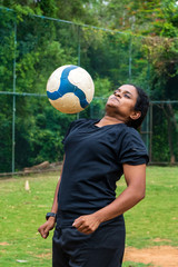 beautiful sporty indian athlete woman playing football