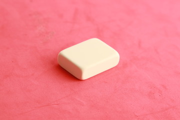 white eraser on color background