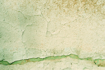 Grunge old painted wall of the house close up green color toned. Abstract background
