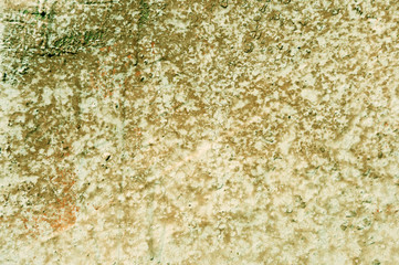 Grunge old painted wall of the house close up green color toned. Abstract background