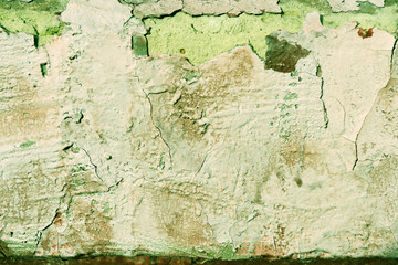Grunge old painted wall of the house close up green color toned. Abstract background