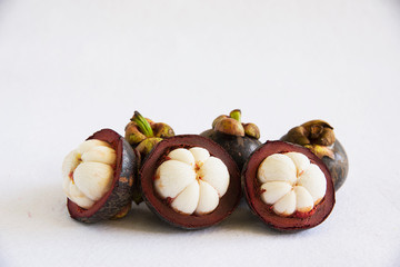 Mangosteen Thai popular fruits - a tropical fruit with sweet juicy white segments of flesh inside a thick reddish-brown rind.