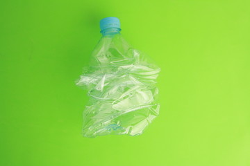 Empty plastic water bottle scaled for recycling