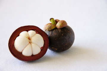 Mangosteen Thai popular fruits - a tropical fruit with sweet juicy white segments of flesh inside a thick reddish-brown rind.