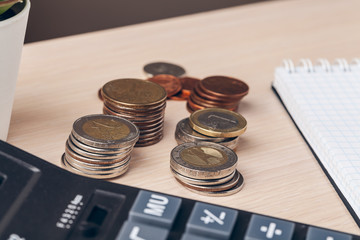 The close-up of  accounting documents with money coins