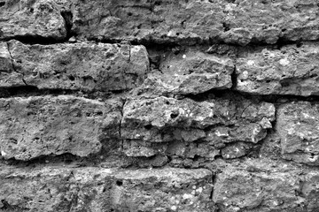Old grungy brick wall texture in black and white.