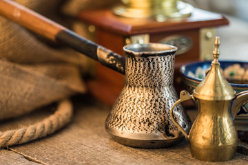 Coffee grinder, turk  of coffee on wooden background