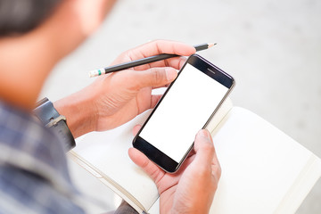Cropped shot view of man hands holding smart phone with blank copy space screen for your text message or information content, female reading text message on cell telephone during in urban setting.