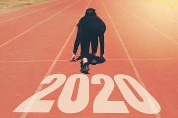 2020 Newyear , Athlete Woman starting on line for start running with number 2020 Start to new year.