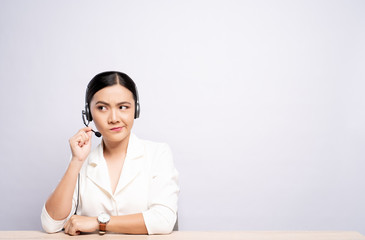 Woman operator in headset feel confuse over white background
