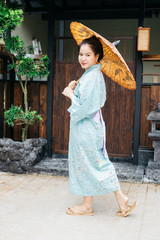 Lifestyle series: Asian woman holding paper umbrella in ryokan
