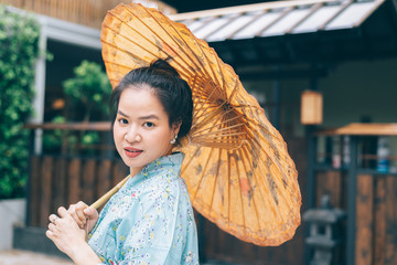 Lifestyle series: Asian woman holding paper umbrella in ryokan
