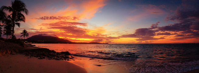 Red sunset panorama on the Caribbean beach with palm trees. Puerto Plata, Dominican Republic,...