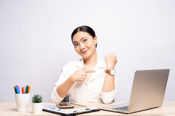 Happy woman holding hand with wrist watch at office isolated over background