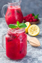 Refreshing raspberry, lemon and mint lemonade with sparkling water in  jar, vertical