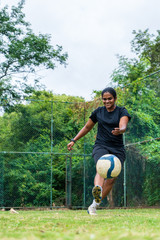 beautiful sporty indian athlete woman playing football
