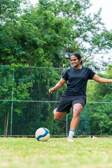 beautiful sporty indian athlete woman playing football