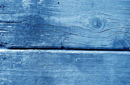 Weathered wooden painted wall in navy blue color.