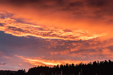 Dramatic orange sky with clouds at sunset. It can be used as a background
