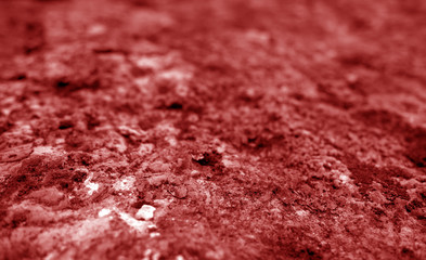 Old stone surface with blur effect in red tone.