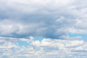 Beautiful white cumulonimbus clouds against the background of the bright blue sky