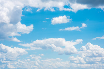 Obraz na płótnie Canvas Beautiful white cumulonimbus clouds against the background of the bright blue sky