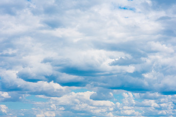 Beautiful white cumulonimbus clouds against the background of the bright blue sky