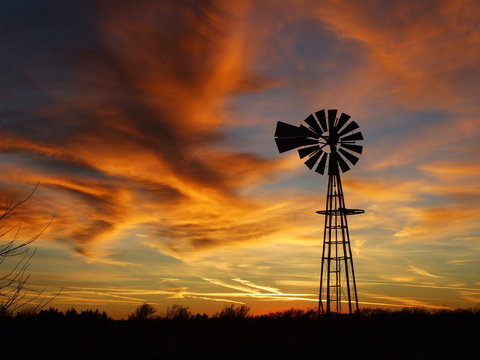Kansas Windmill at Sunset with colorful clouds.