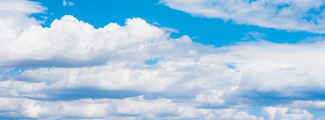 Beautiful white cumulonimbus clouds against the background of the bright blue sky