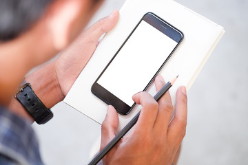  Cropped shot view of man hands holding smart phone with blank copy space screen for your text message or information content, female reading text message on cell telephone during in urban setting. 