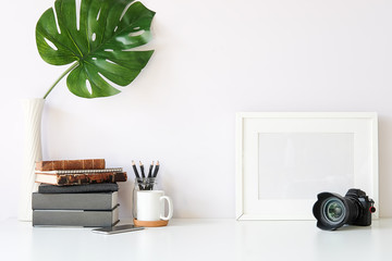 Mockup workspace desk and copy space books,plant and coffee on white desk.