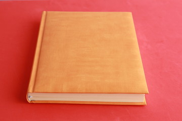 book with orange cover on colorful background