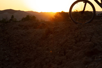 Man with mountain bike at sunrise
