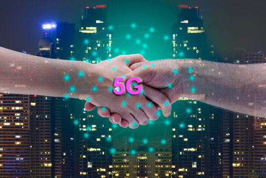 Double exposure business handshake for successful in business investment under best signal internet connection 5g system with blur night city background.