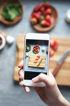 Woman photographing food to post on social network