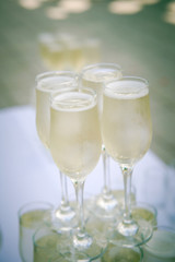 Glasses with champagne. Festive event. White sparkling wine. Wedding. Champagne on the table
