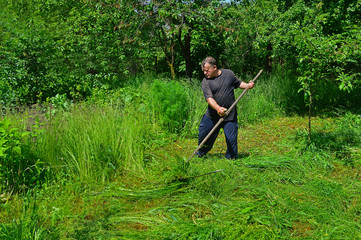 A man mowing grass