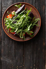 Obraz na płótnie Canvas healthy Greek salad with juicy tomatoes feta cheese olives cucumber basil arugula
