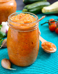 Delicious squash caviar in a jar on the table. Homemade caviar with zucchini, garlic, carrots, tomato sauce. Vegan cuisine.