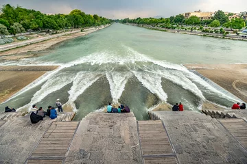 Wall murals Khaju Bridge 22/05/2019 Isfahan, Iran, Iranian people sit and have a rest on Khaju Bridge over the Zayandeh river, this is a traditional hangout and rest in Isfahan
