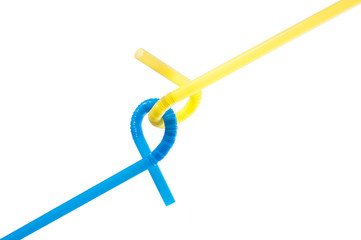 Blue and yellow drinking straws tied with each other