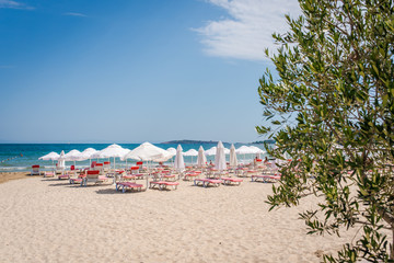 Summer beach with deck chairs and umbrellas. 