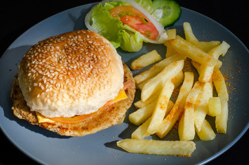 Durban cuisine: A spicy chicken and cheese burger served with chips/fries and a salad