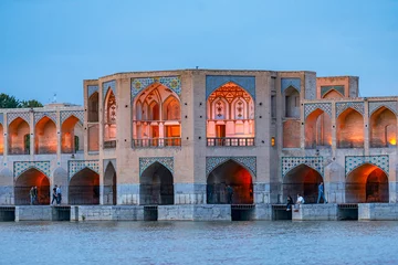 Papier Peint photo autocollant Pont Khadjou 22/05/2019 Isfahan, Iran, Khaju Bridge with plenty of people over Zayandeh river is iluminated at dusk with lights, Serving as a dam as well