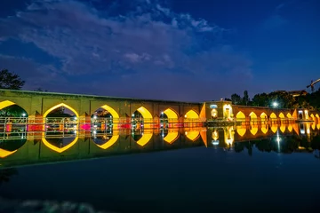 Photo sur Plexiglas Pont Khadjou 22/05/2019 Isfahan, Iran, little and cozy Chobi Bridge at evening alredy iluminated over river Zayanderud in city Isfahan