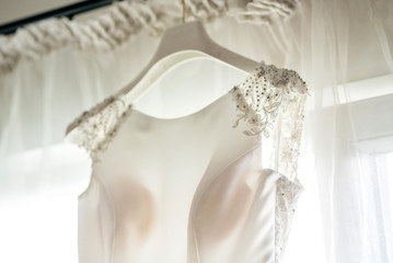 Close up of a beautiful wedding dress on a hanger