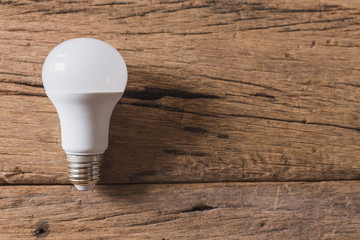 Top view of Light bulb on wood background and copy space