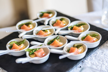 Tuna fish slices with green aspargus finger food. Catering food for a special event. Luxury catering food.
